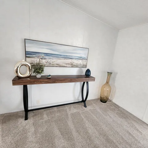 a view of staircase with a table and a fireplace
