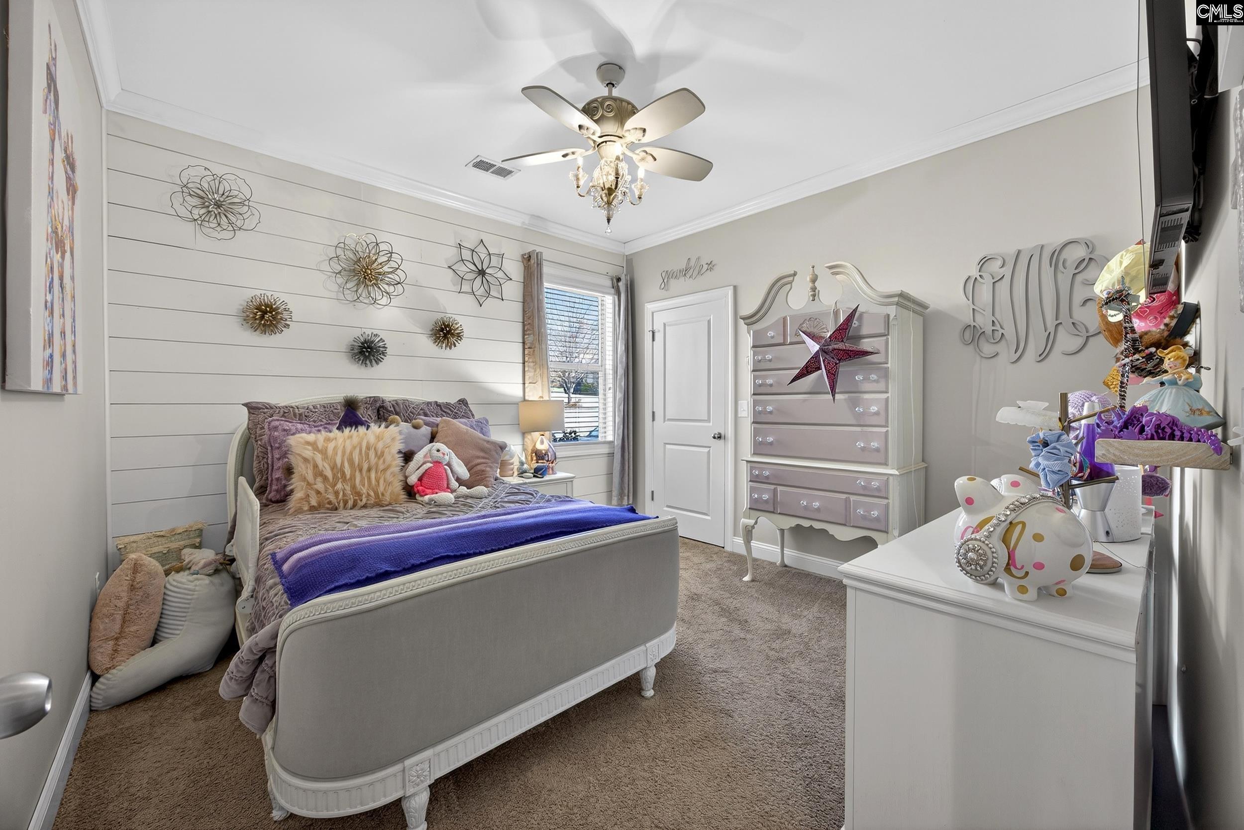 116 Renard Way Gilbert, SC 29054 - Photo 46 of 74 a bedroom with a bed and a chandelier