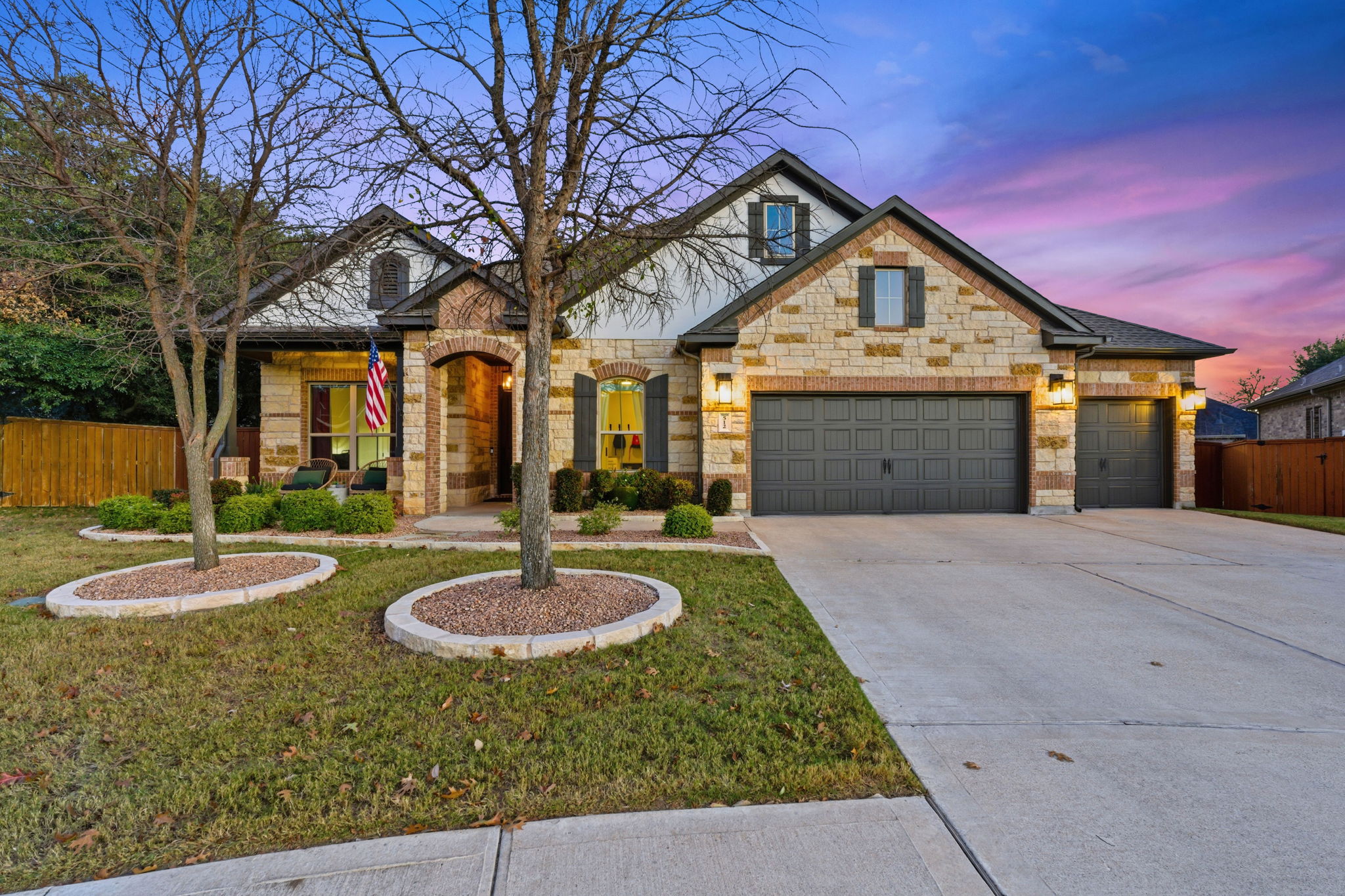 View of front of house featuring concrete driveway and a garage