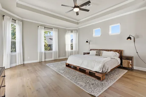 a spacious bedroom with a bed and window