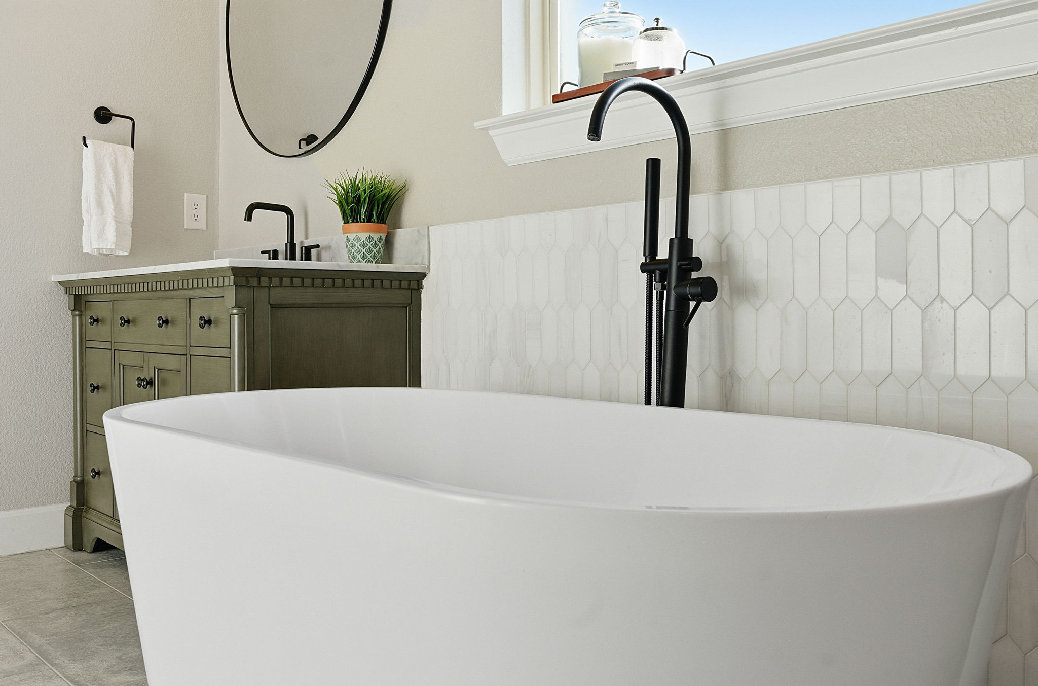 512 Choke Canyon Lane Georgetown, TX 78628 - Photo 16 of 37 Full bath with vanity, a freestanding tub, and light tile patterned flooring