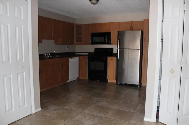 a kitchen with a refrigerator and a stove