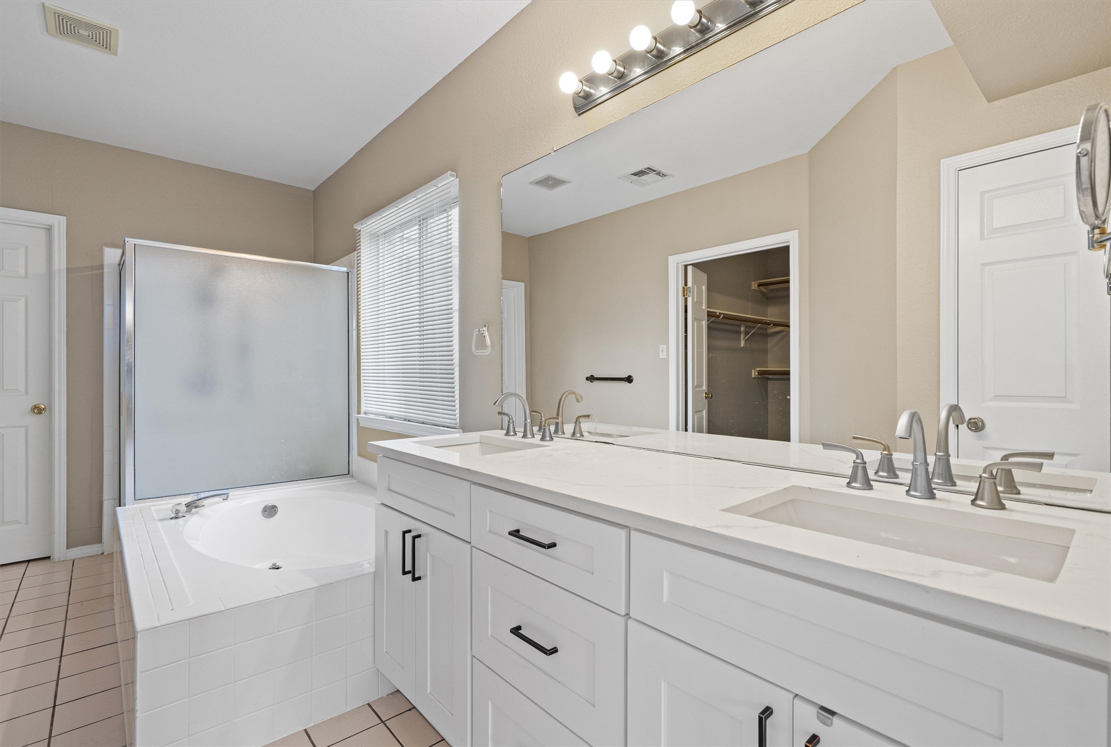 100 Parque Circle Georgetown, TX 78626 - Photo 20 of 39 a bathroom with a sink double vanity granite tub shower and a mirror