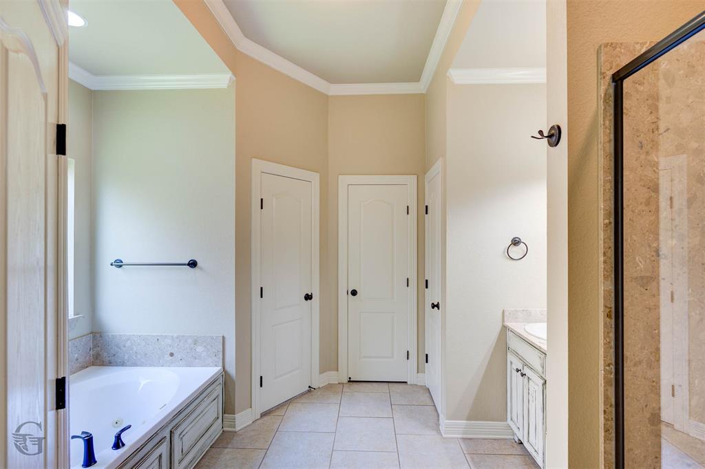 830 Entrada Bossier City, LA 71111 - Photo 11 of 25 a bathroom with a granite countertop tub shower and a sink