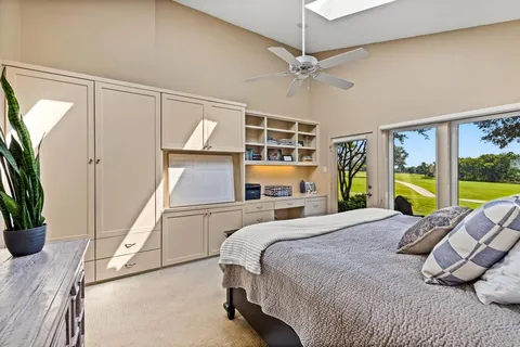 a bedroom with a bed mirror and table