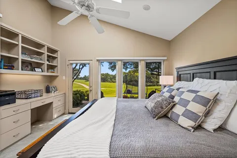 a spacious bedroom with a bed and a large window