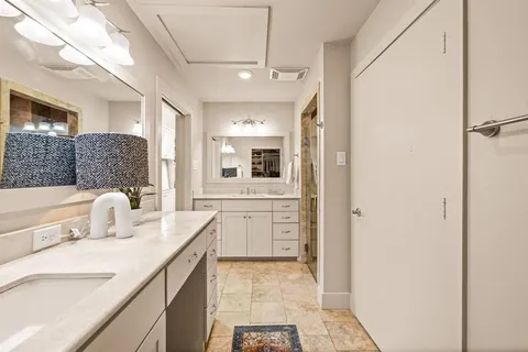 a bathroom with a sink double vanity and a mirror