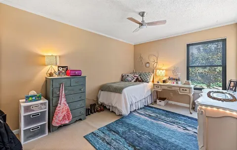 a bed room with a bed and a window