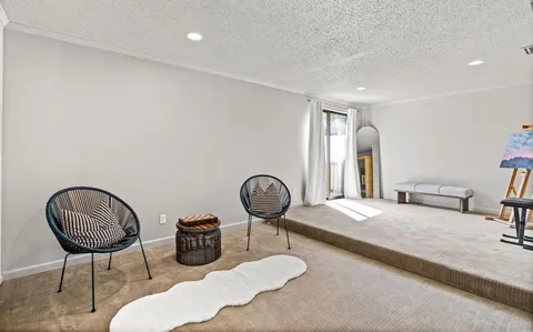 a bedroom with bed and a chair