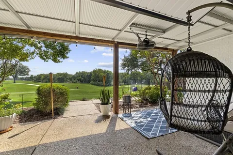 a view of a porch with a table chairs and a backyard