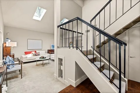 a living room with table and stairs