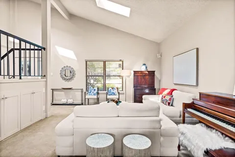 a living room with furniture a fireplace and a window