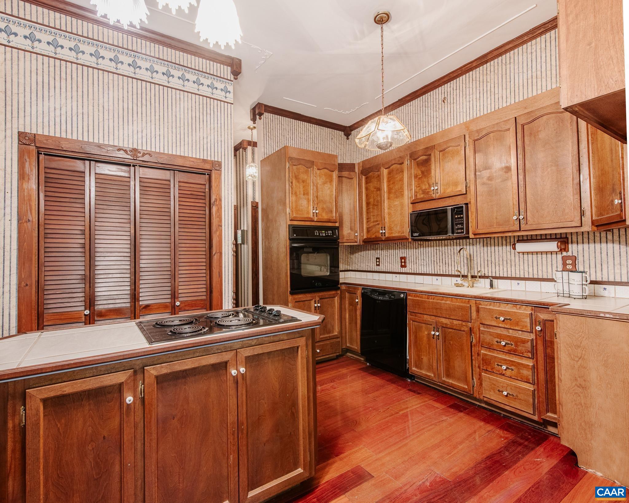 87 Retriever Ridge Drive Gordonsville, VA 22942 - Photo 19 of 41 a kitchen with stainless steel appliances granite countertop a stove a sink dishwasher and a microwave oven with cabinets
