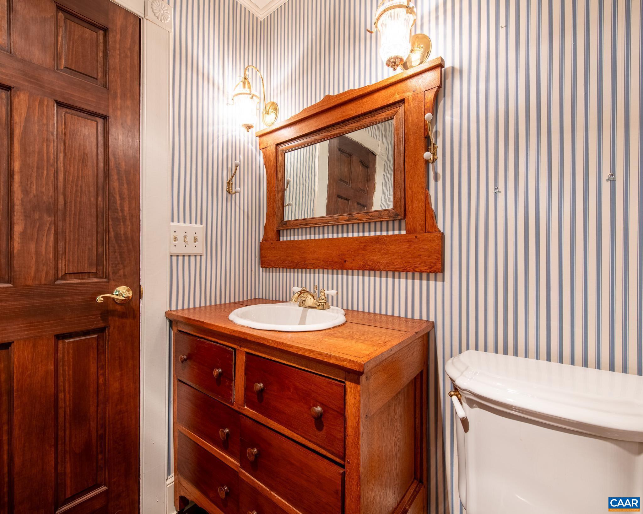 87 Retriever Ridge Drive Gordonsville, VA 22942 - Photo 30 of 41 a bathroom with a sink a toilet and mirror