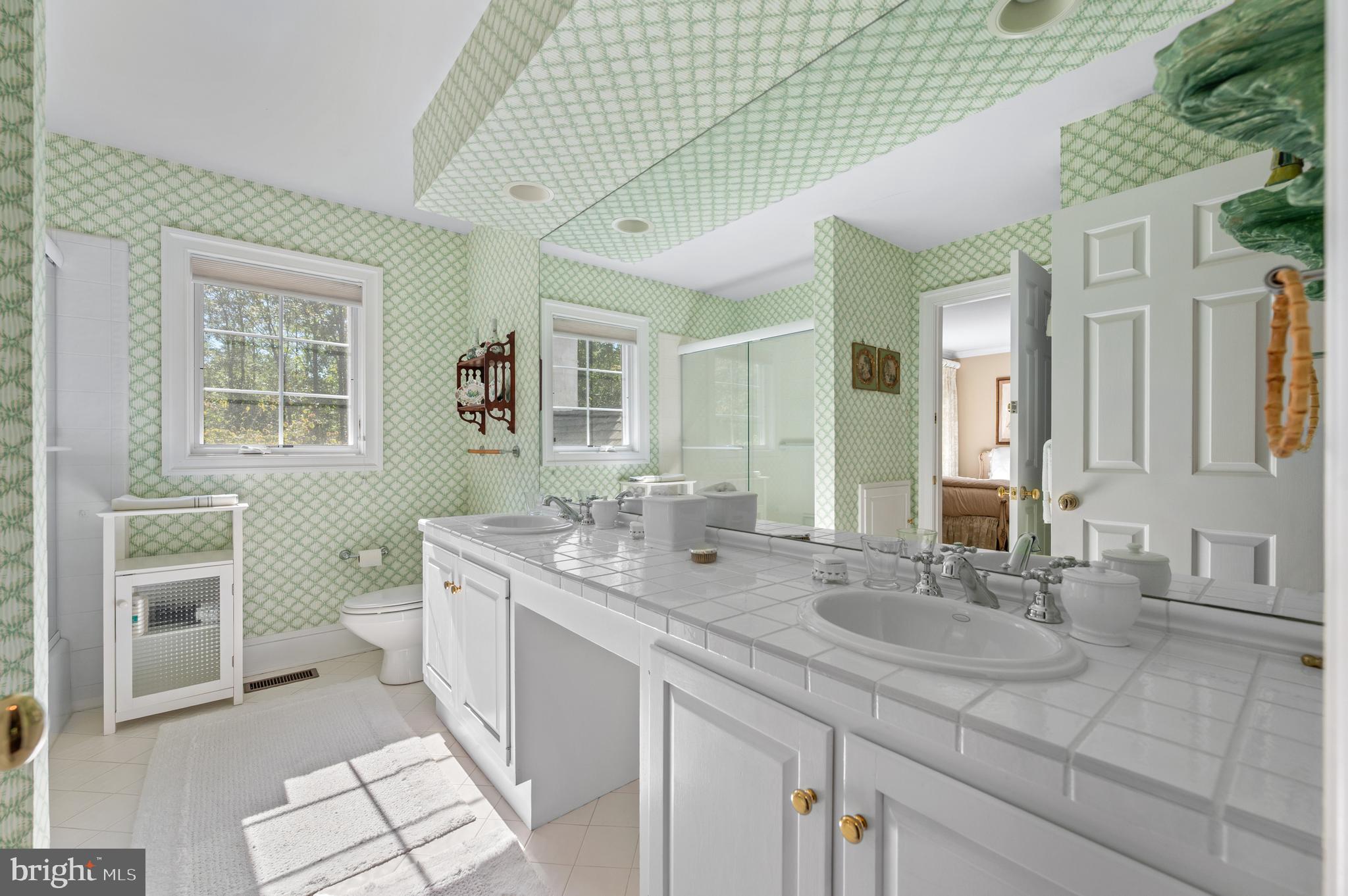 1236 Denbigh Lane Wayne, PA 19087 - Photo 29 of 36 a spacious bathroom with a double vanity sink a mirror and a toilet