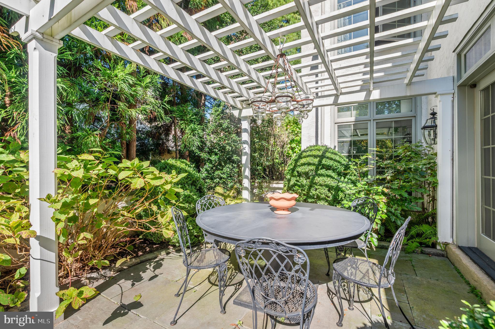 1236 Denbigh Lane Wayne, PA 19087 - Photo 4 of 36 a view of a patio with table and chairs and potted plants