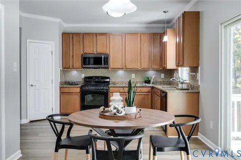 a kitchen with a table chairs a sink and dishwasher