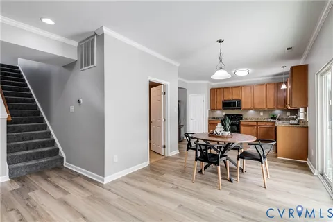 a view of a dining room with furniture and wooden floor