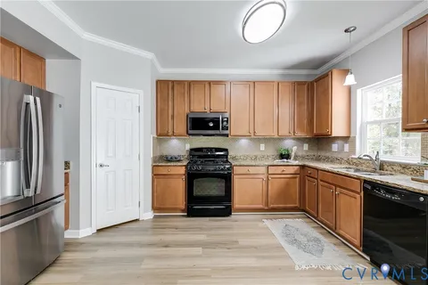a kitchen with granite countertop stainless steel appliances and wooden cabinets