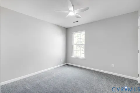 a view of an empty room and closet area