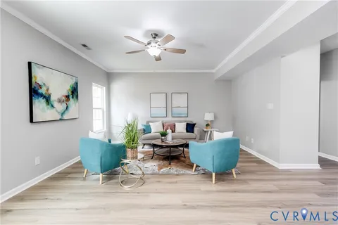 a living room with furniture and a chandelier