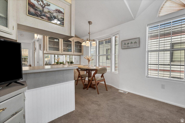 2990 East Riverside Drive, Unit 173 St. George, UT 84790 - Photo 5 of 38 Dining area featuring a vaulted ceiling and carpet flooring
