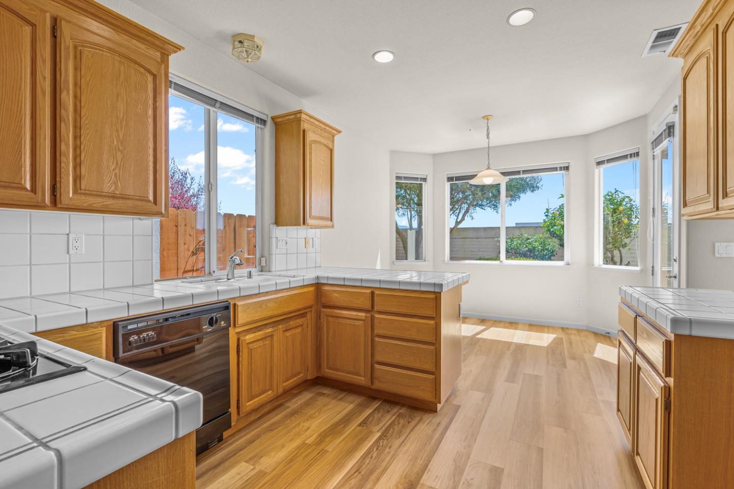215 Montclair Lane Salinas, CA 93906 - Photo 12 of 40 a large kitchen with a window wooden floor and stainless steel appliances