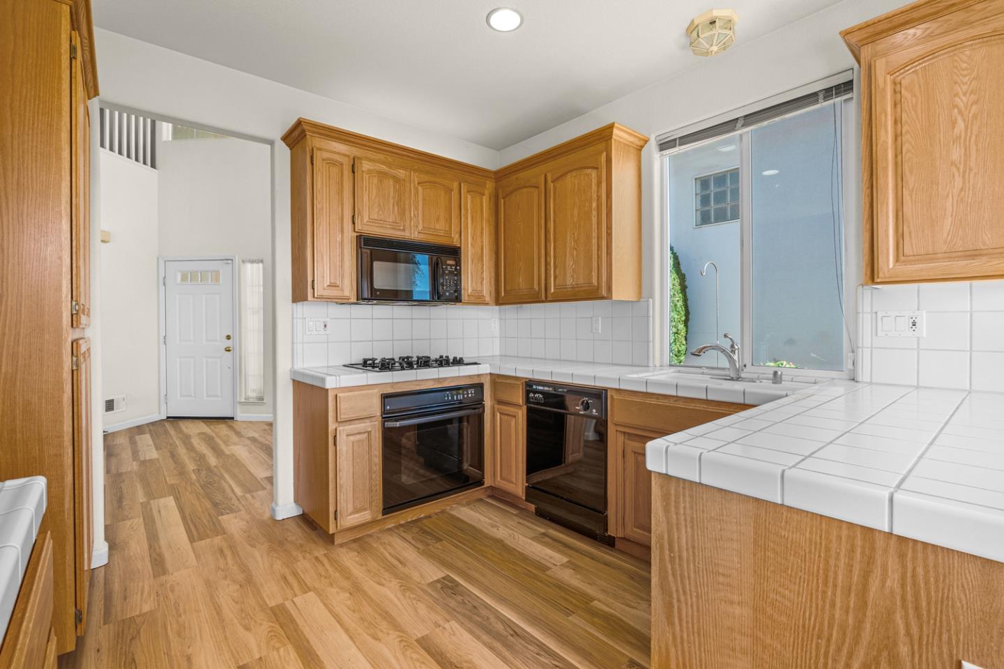 215 Montclair Lane Salinas, CA 93906 - Photo 14 of 40 a kitchen with granite countertop a stove a sink and a refrigerator