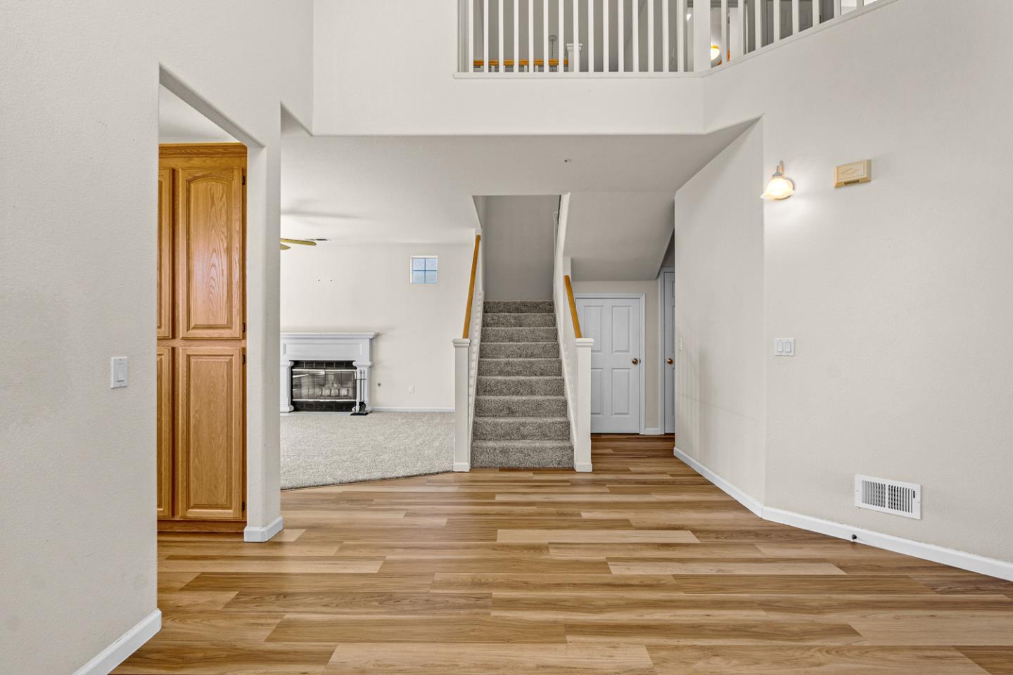 215 Montclair Lane Salinas, CA 93906 - Photo 10 of 40 a view of a livingroom with wooden floor and stairs