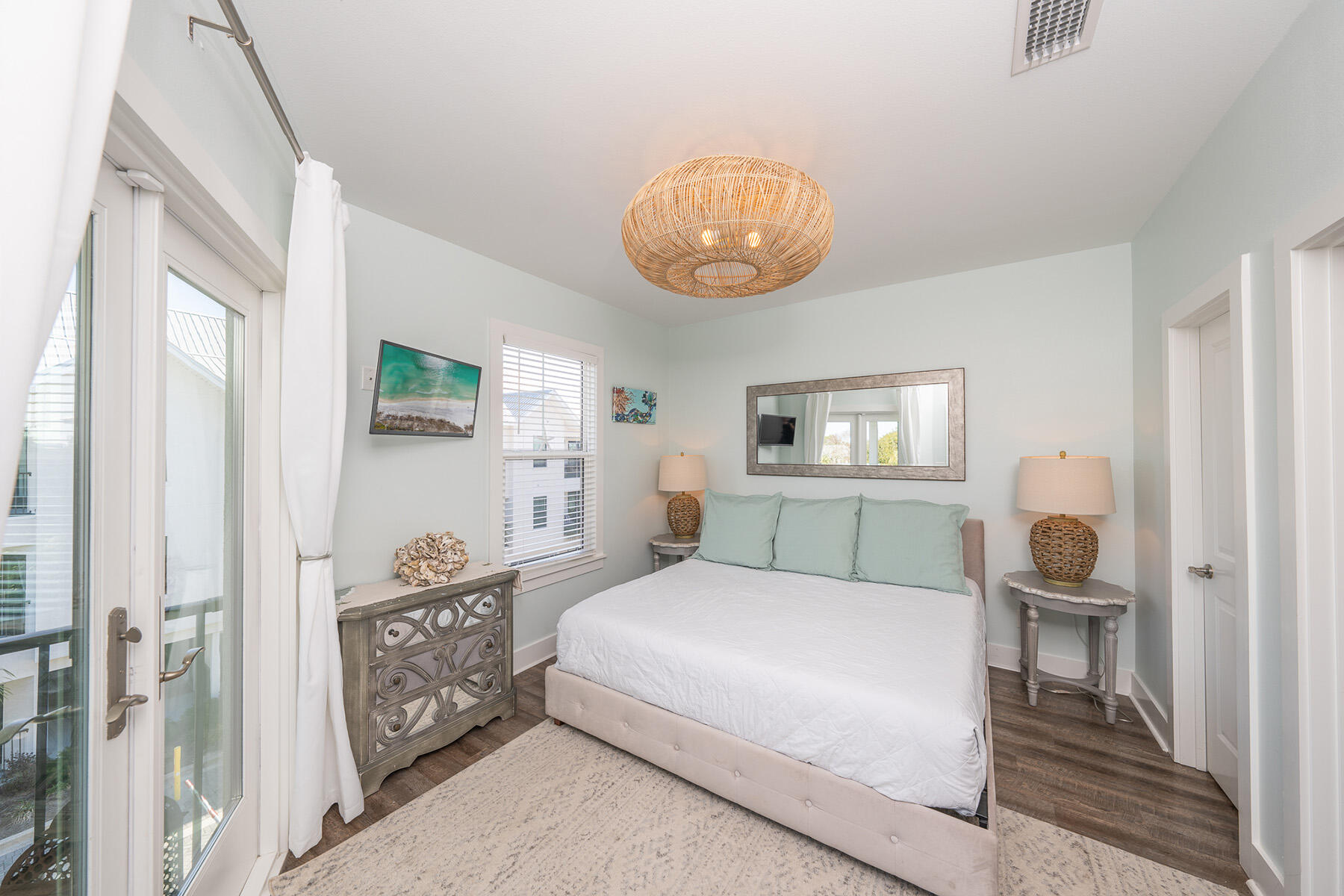 3986 West Hidden Lake Way, Unit 231 Santa Rosa Beach, FL 32459 - Photo 15 of 66 a bedroom with a bed and a chandelier next to a window