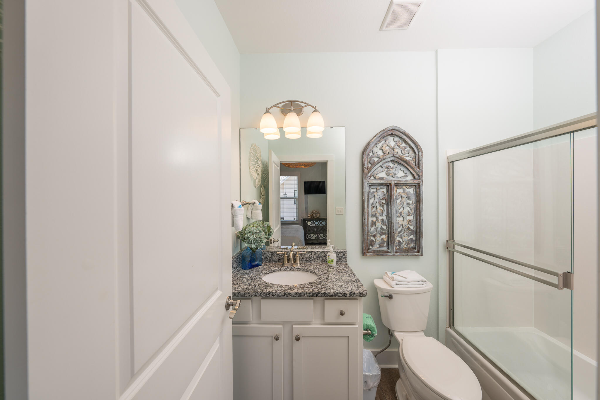 3986 West Hidden Lake Way, Unit 231 Santa Rosa Beach, FL 32459 - Photo 16 of 66 a bathroom with a toilet a sink a mirror and a shower