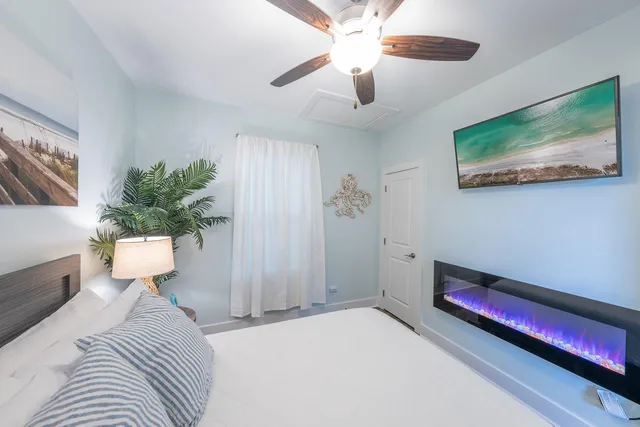 a view of a house with a small yard and potted plants
