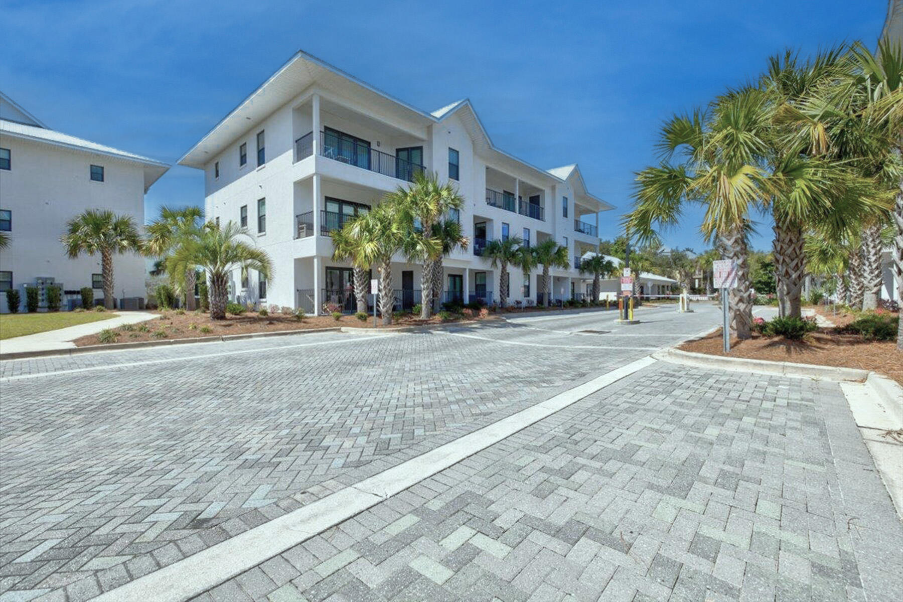 3986 West Hidden Lake Way, Unit 231 Santa Rosa Beach, FL 32459 - Photo 5 of 66 a front view of a building with palm trees