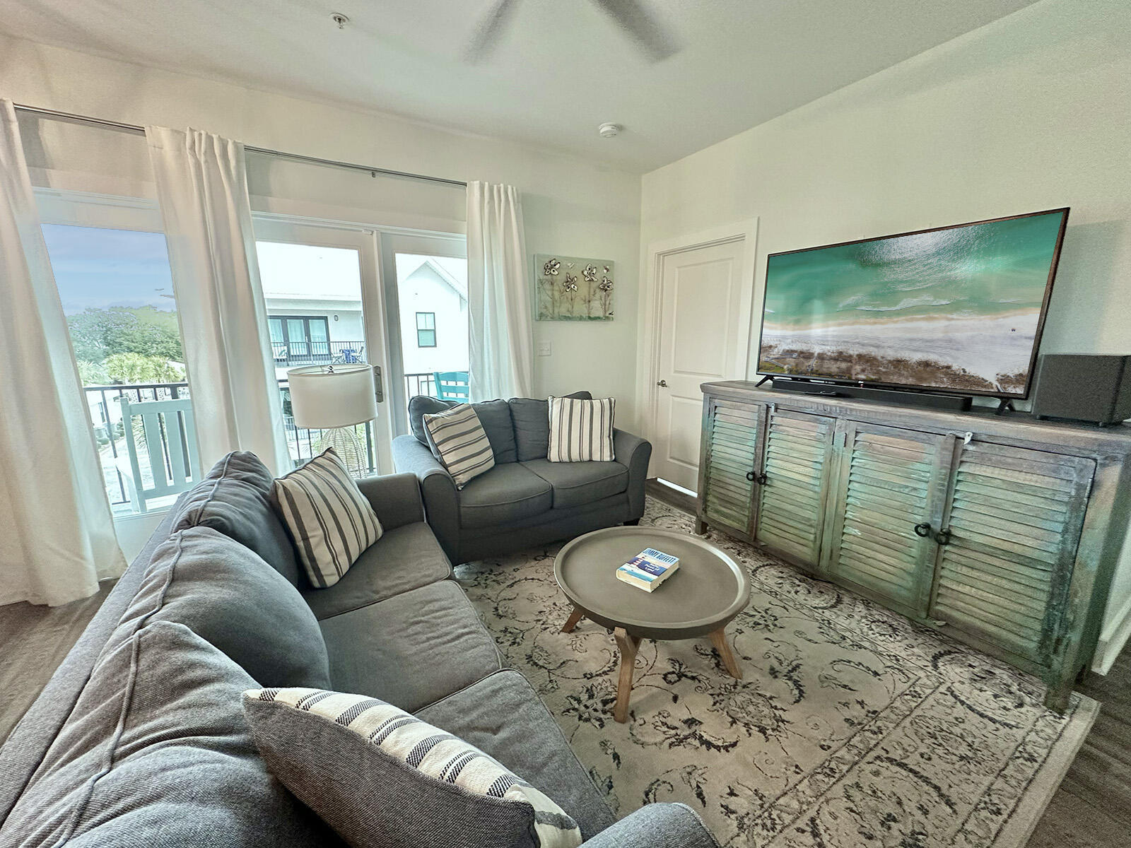 3986 West Hidden Lake Way, Unit 231 Santa Rosa Beach, FL 32459 - Photo 8 of 66 a living room with furniture and a flat screen tv