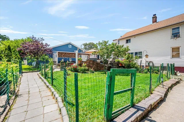 a front view of a house with a yard table and chairs