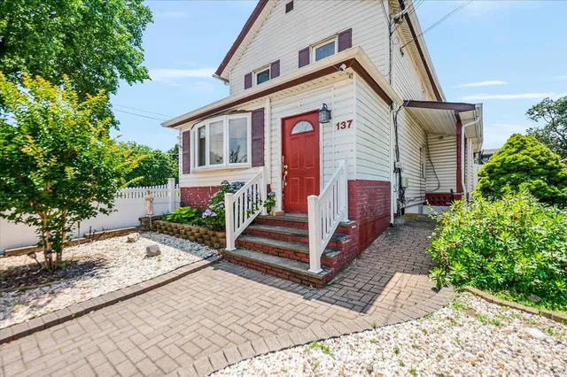 a front view of a house with garden
