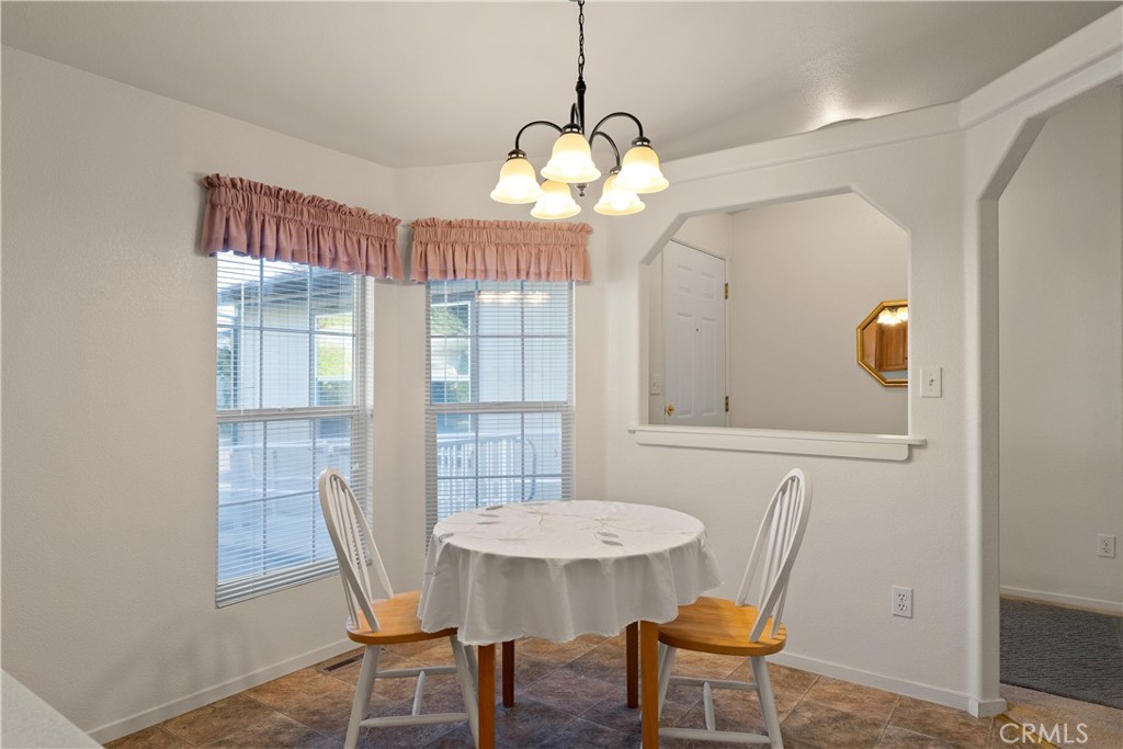 2050 Springfield Drive, Unit 143 Chico, CA 95928 - Photo 11 of 43 a view of a dining room with furniture and wooden floor