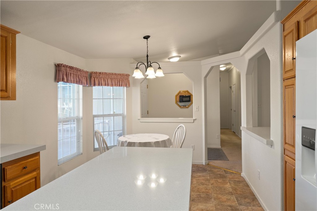 2050 Springfield Drive, Unit 143 Chico, CA 95928 - Photo 15 of 43 a dining room with wooden floor and chandelier