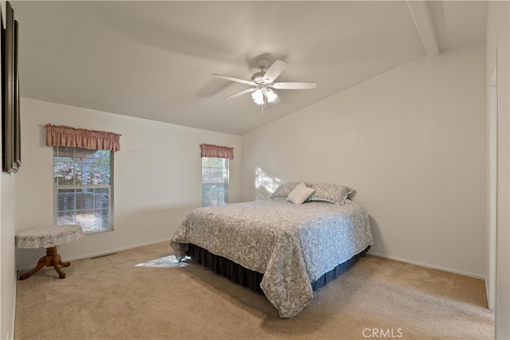 2050 Springfield Drive, Unit 143 Chico, CA 95928 - Photo 17 of 43 a bedroom with a bed and a chandelier