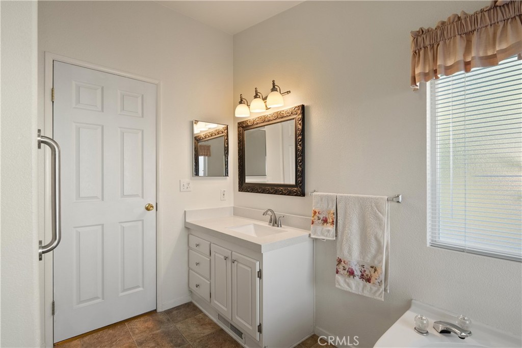 2050 Springfield Drive, Unit 143 Chico, CA 95928 - Photo 19 of 43 a bathroom with a sink vanity and mirror