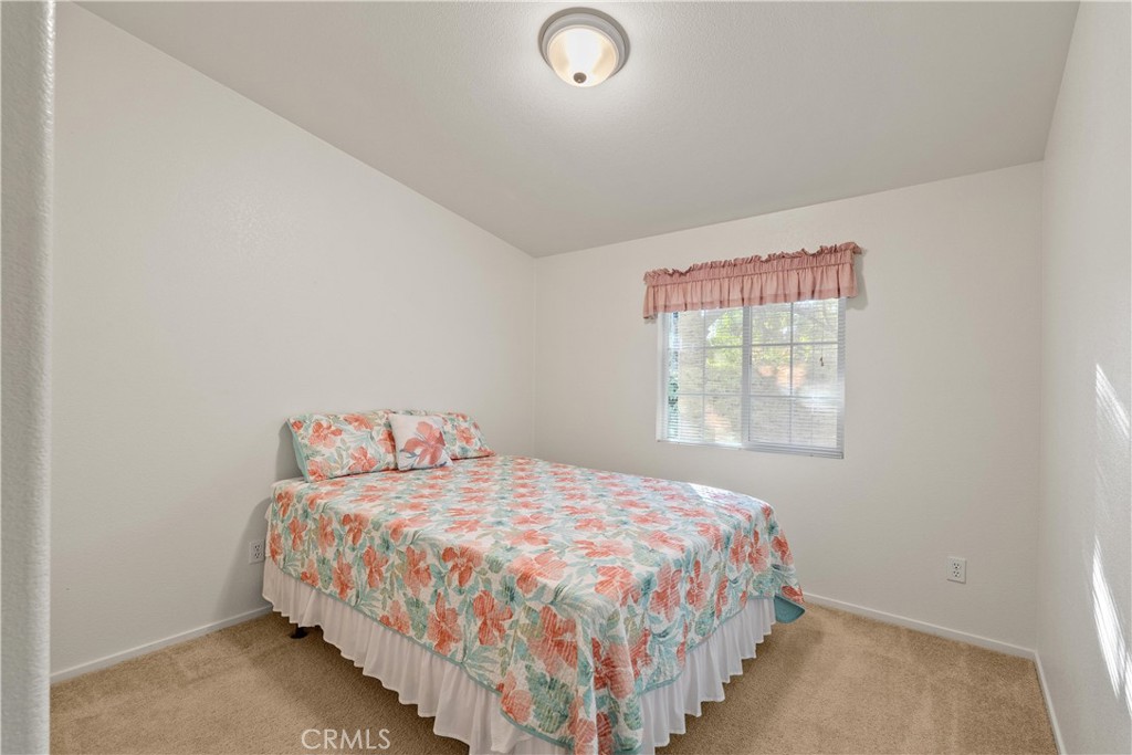 2050 Springfield Drive, Unit 143 Chico, CA 95928 - Photo 21 of 43 a bedroom with a bed and a window