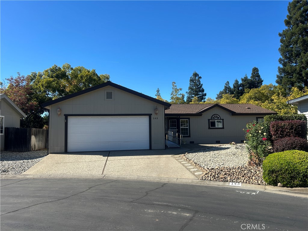 2050 Springfield Drive, Unit 143 Chico, CA 95928 - Photo 43 of 43 a front view of a house with a yard and garage