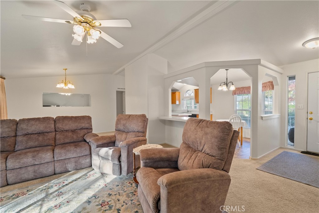 2050 Springfield Drive, Unit 143 Chico, CA 95928 - Photo 8 of 43 a living room with furniture and a chandelier