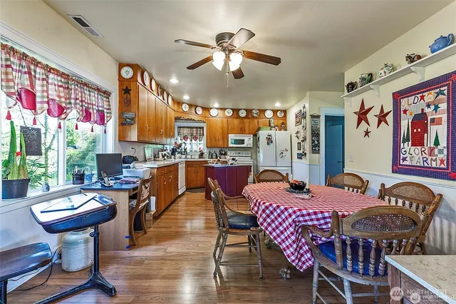 a view of a dining room with furniture a chandelier and wooden floor