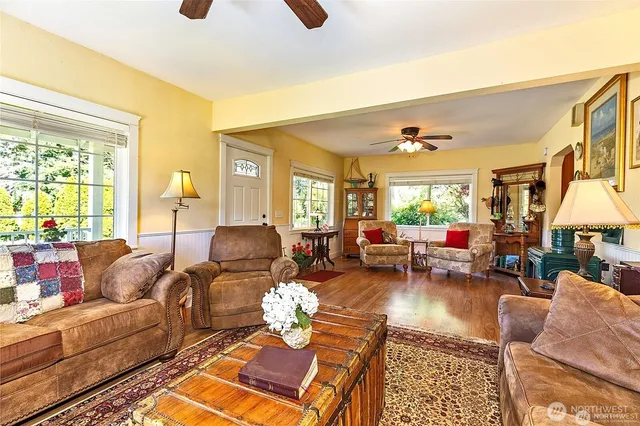 a living room with furniture fireplace and a large window