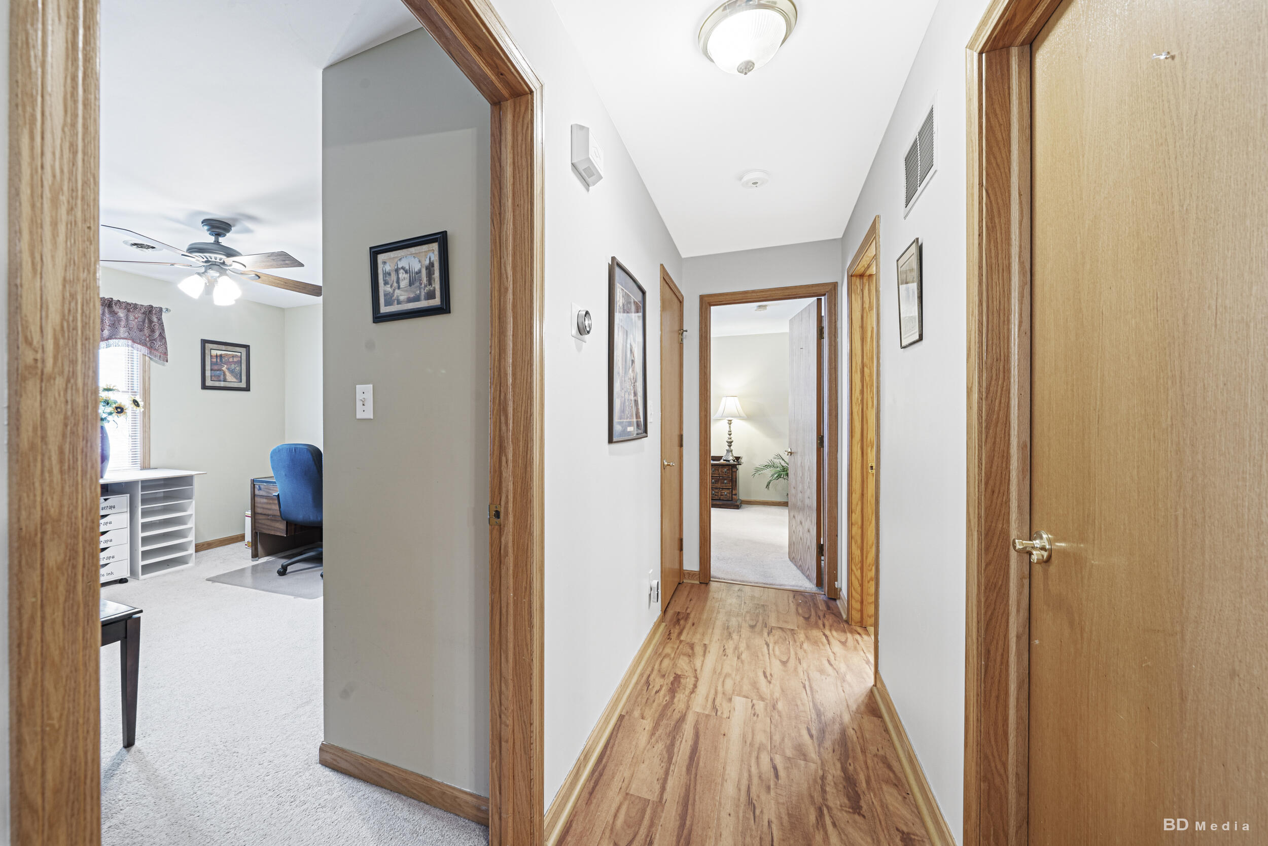 925 Cedar Drive Crown Point, IN 46307 - Photo 9 of 16 a view of a hallway with wooden floor and staircase