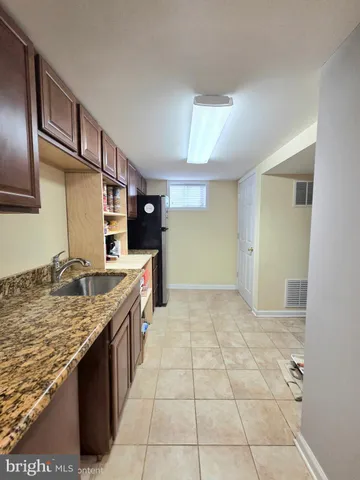 a kitchen with granite countertop a sink and a stove