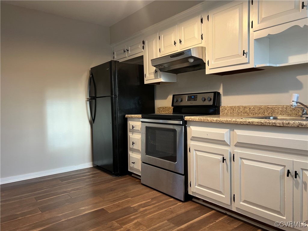 Kitchen featuring electric stove, dark wood finish