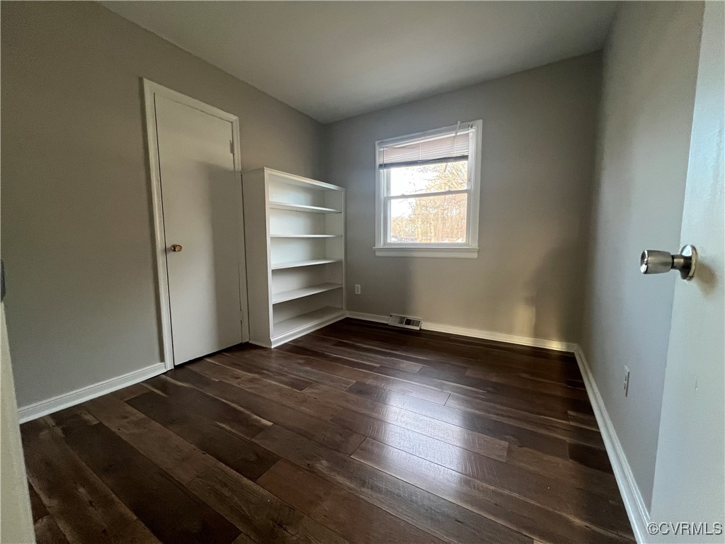 4101 Norborne Road Richmond, VA 23234 - Photo 9 of 10 Unfurnished bedroom featuring dark wood-style floo