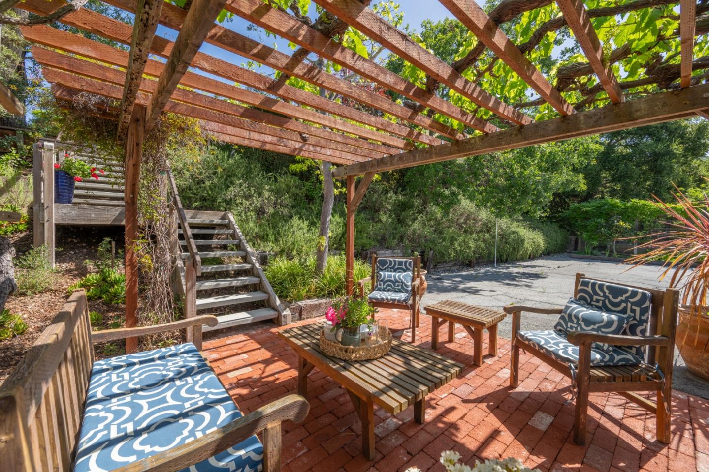 46 Middle Canyon Road Carmel Valley, CA 93924 - Photo 57 of 74 a view of a patio with table and chairs and couches with wooden floor and fence
